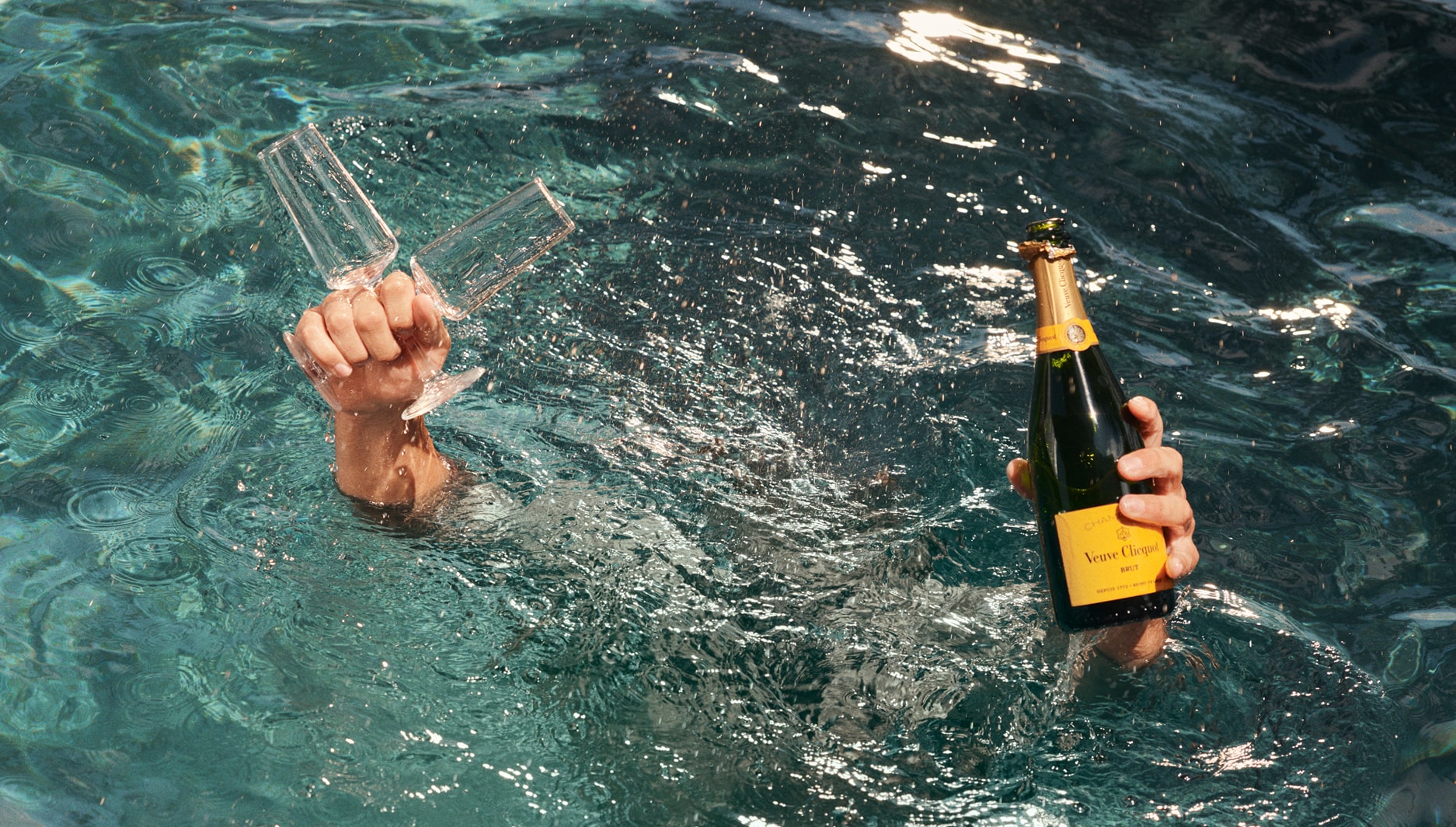 this image depicts a person celebrating in a pool